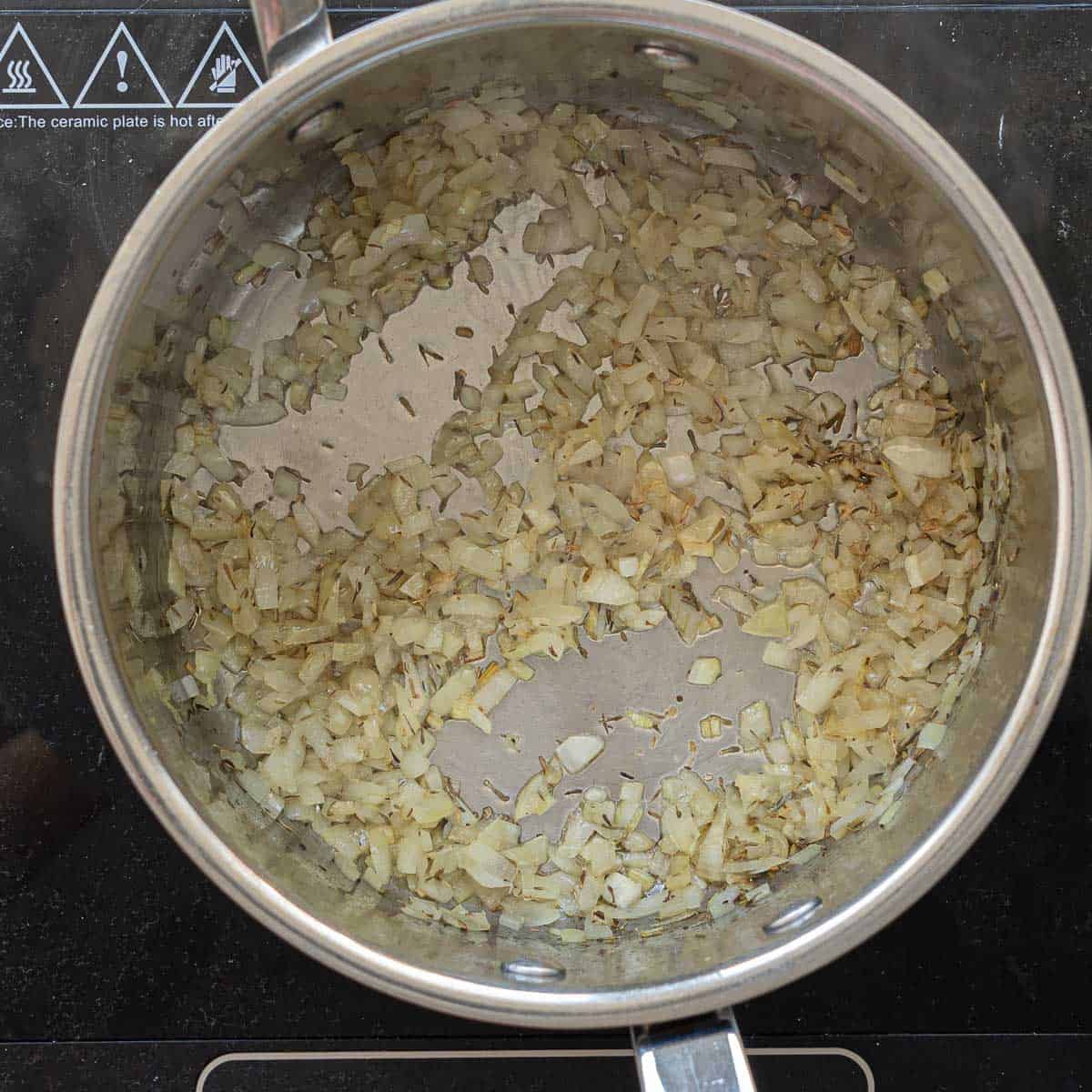 Sautéed finely diced onion and thyme in the bottom of a large saucepan.