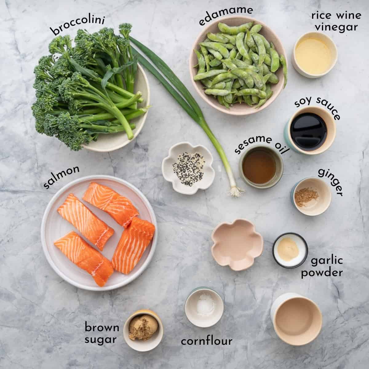 Ingredients for baked salmon on benchtop with text overlay.