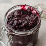 Open jar with blueberry chia jam filled to the top.