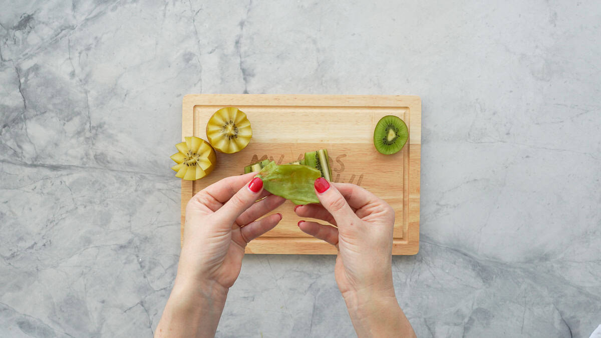 An eaten quarter of a kiwi fruit, all that is left is the peel.