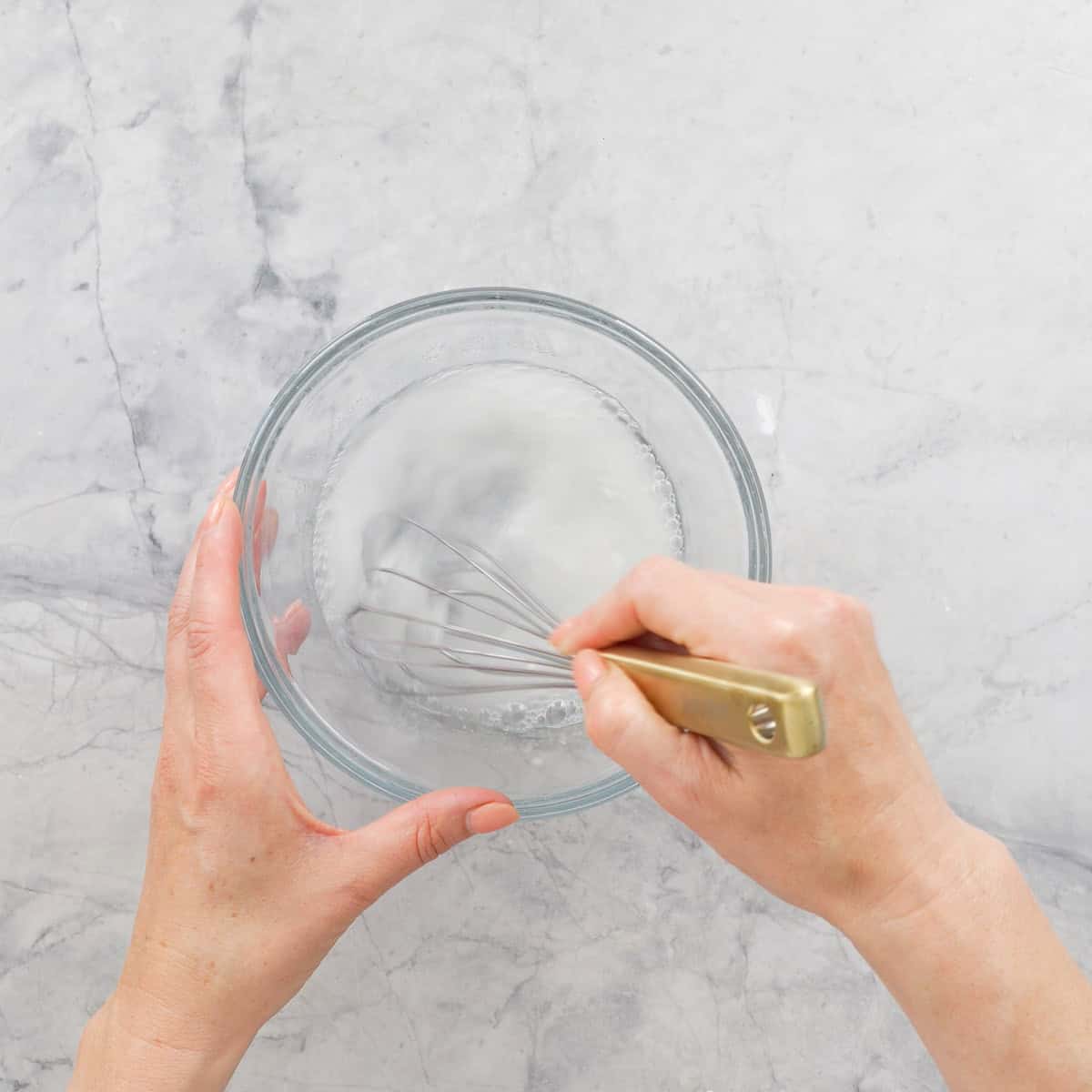 Ingredients for Rice Vinegar being whisked together in a bowl.