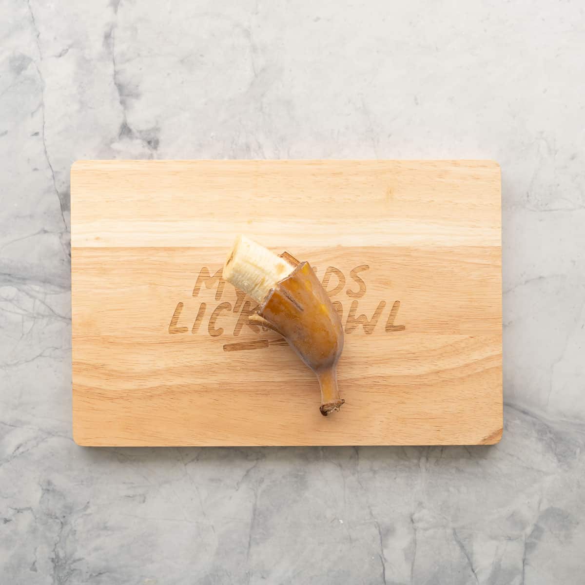 A half a banana with peal chopped half way down exposing the banana inside.