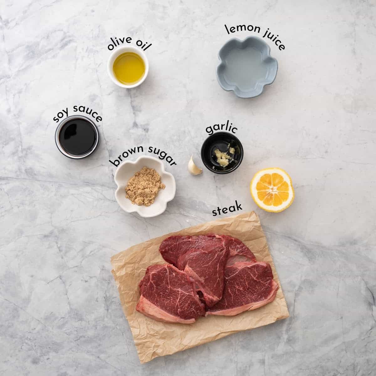 Ingredients for steak marinade on bench top with text overlay.