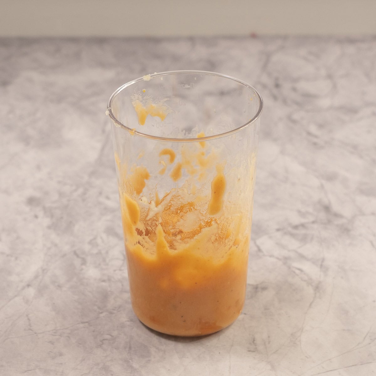 Sweet potato puréed inside a tall glass cup.