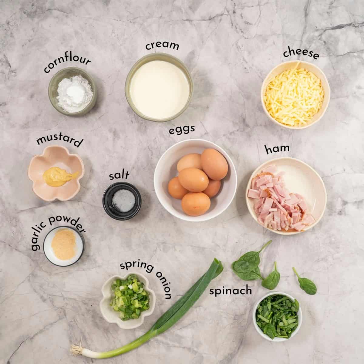 Ingredients for Crustless quiche on benchtop with text overlay.