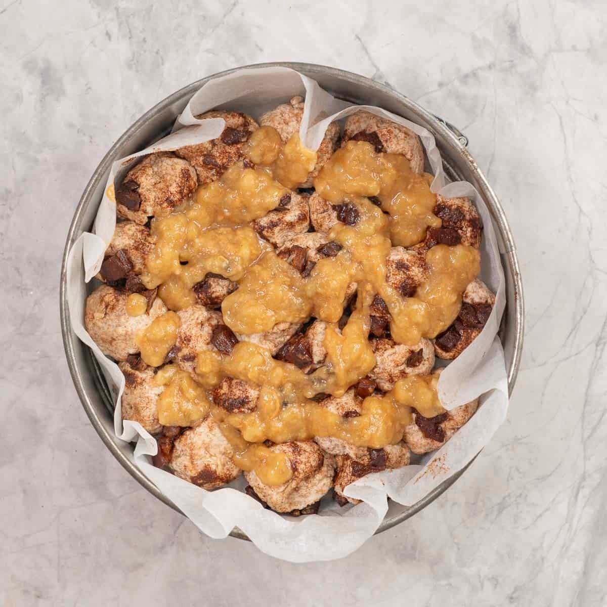 Almond/peanut butter, maple syrup, applesauce, and salt mixture poured over top of monkeybread.
