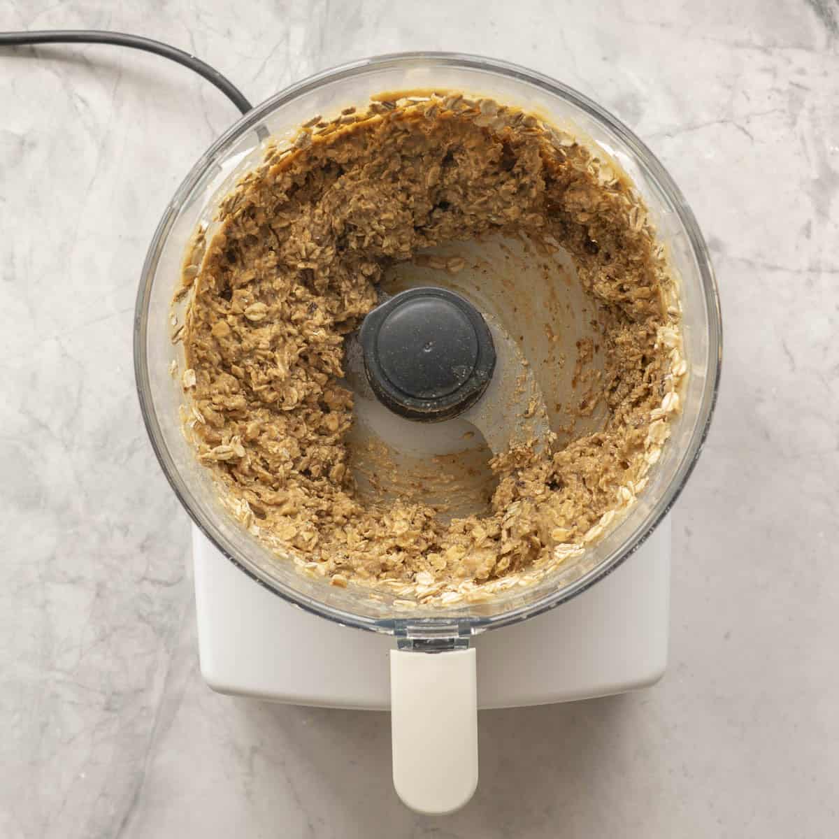 Apple sauce, peanut butter, raisins and oats blended together in a food processor on bench top.