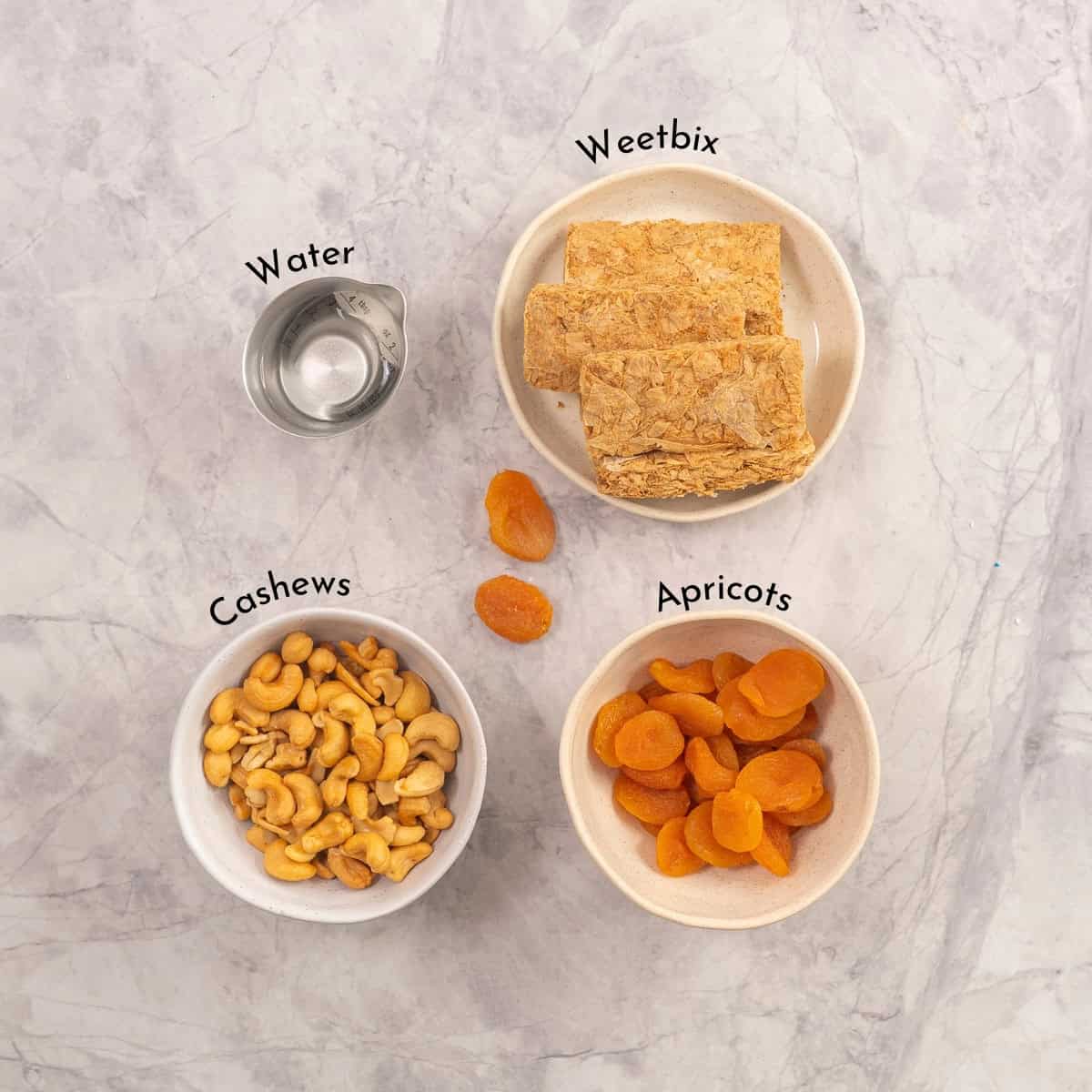 Ingredients for Apricot Bars on benchtop with text overlay.