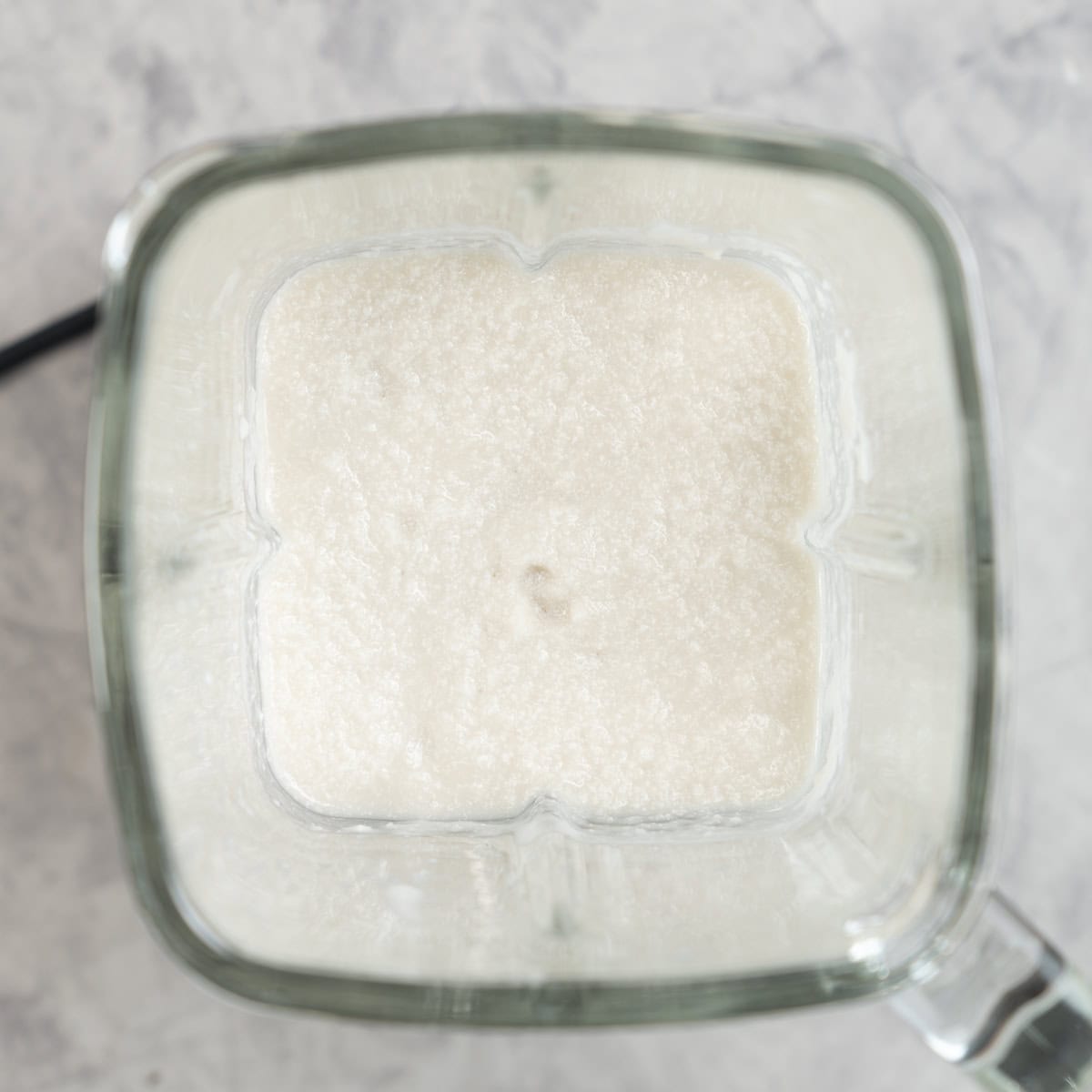 Coconut and cauliflower blended together in blender.