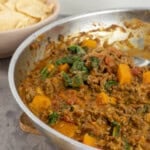 Pan of mince curry on benchtop.
