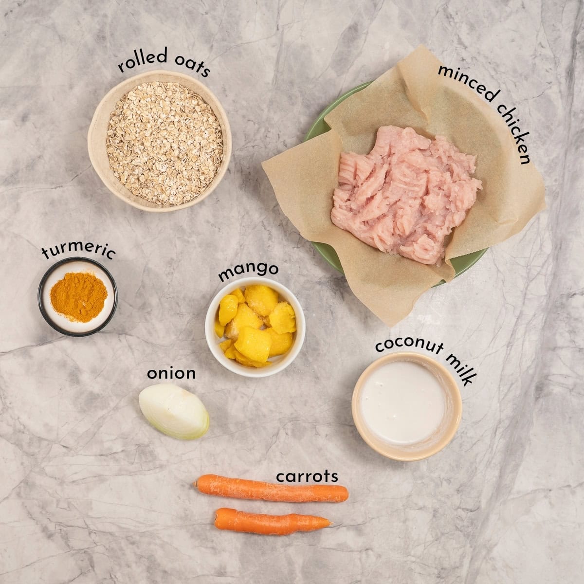 Ingredients for soft chicken mango meatballs on a marble surface.