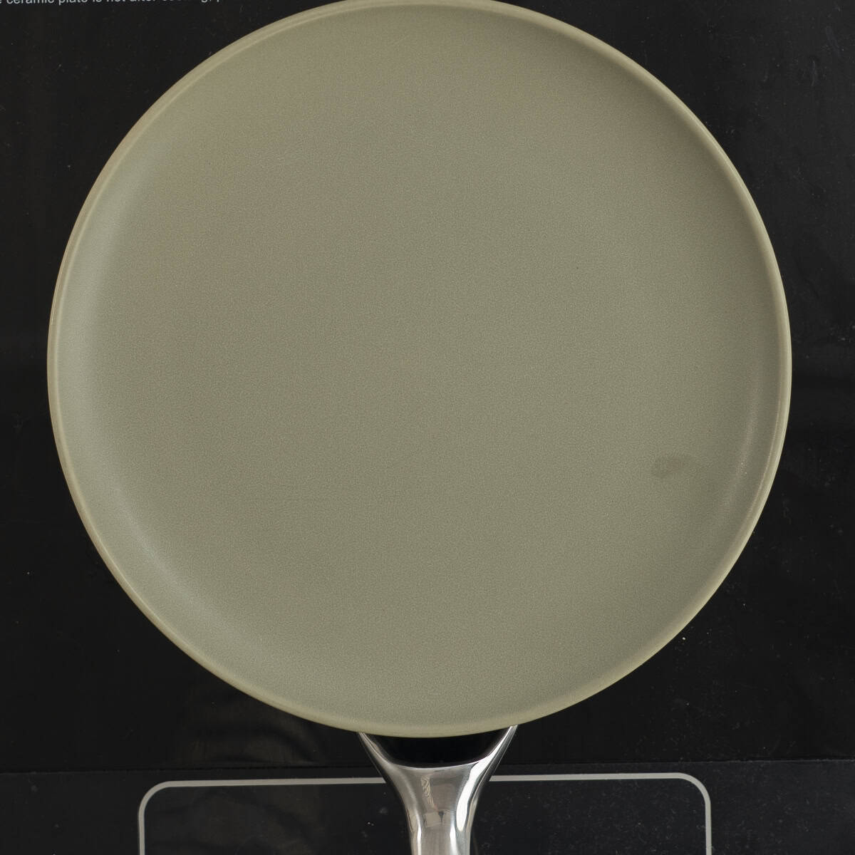 A plate on top of skillet with pizza egg inside.