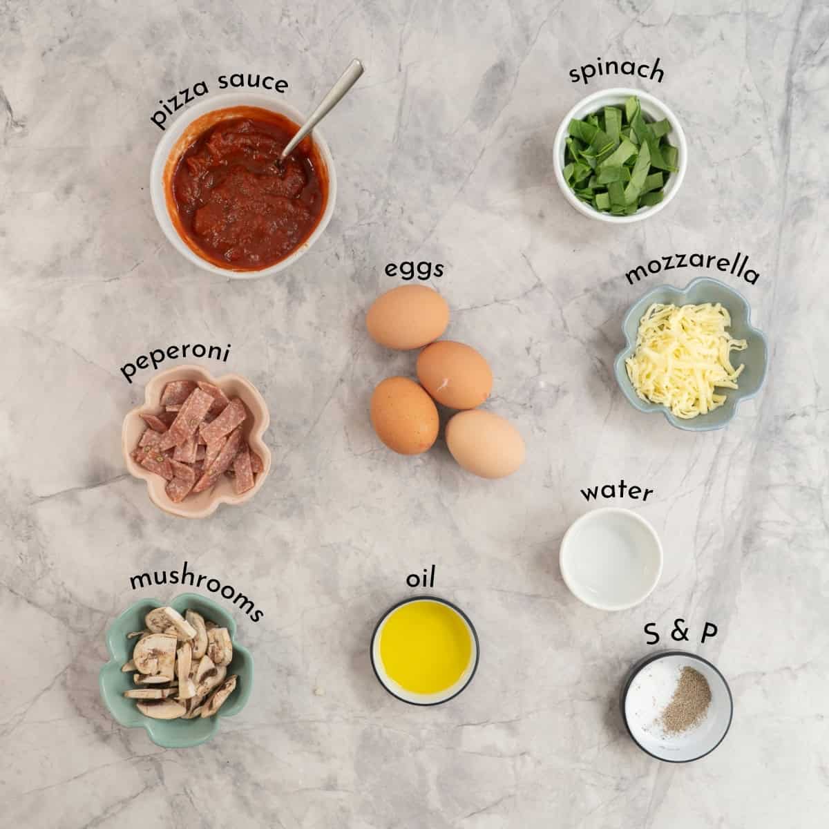Ingredients for Pizza eggs on marble bench top with text overlay.