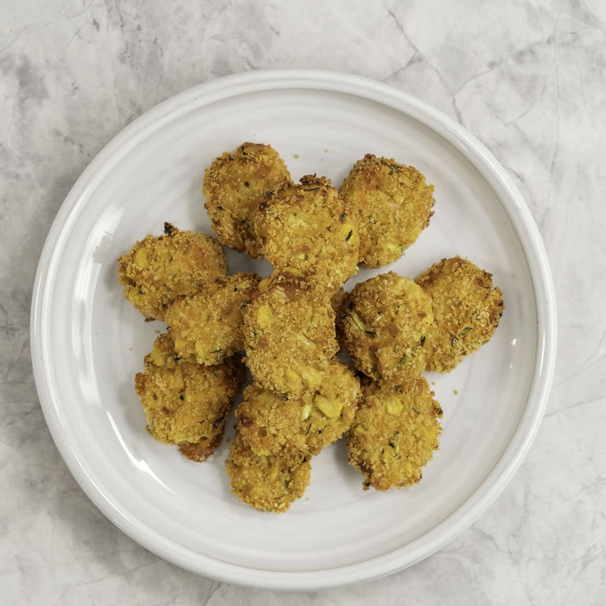 Dinner plate with stack of crispy nuggets.