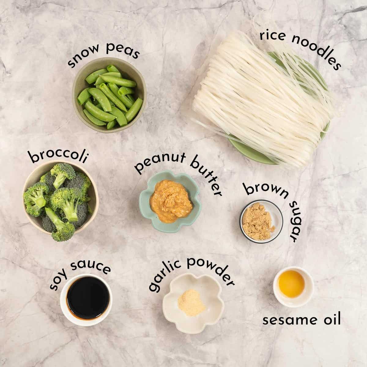 Ingredients for Peanut butter noodles on benchtop with text overlay.
