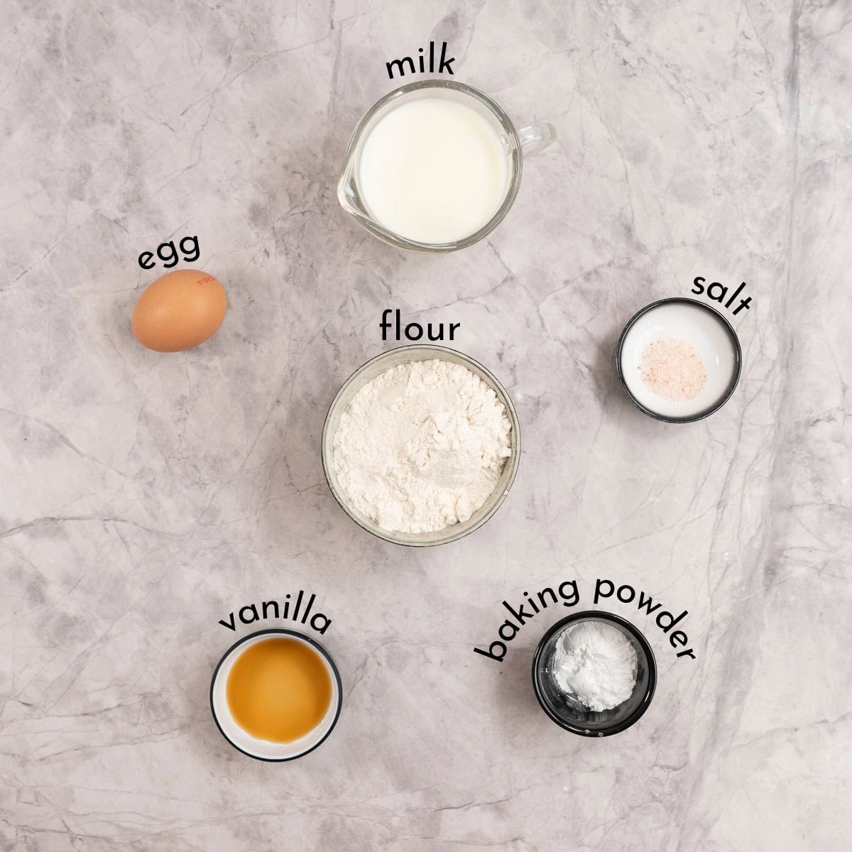 Ingredients for mini pancakes on marble bench top with text overlay.